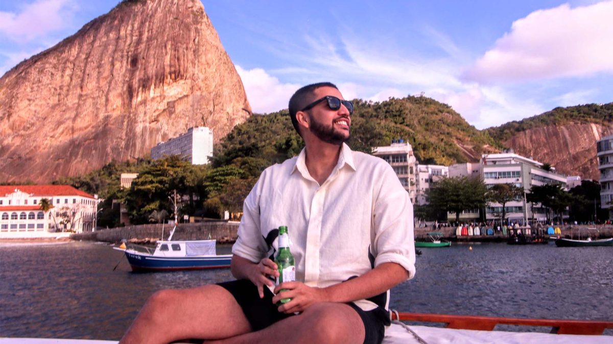 garoto-passeio-de-barco-ddrio-pao-de-acucar-ao-fundo